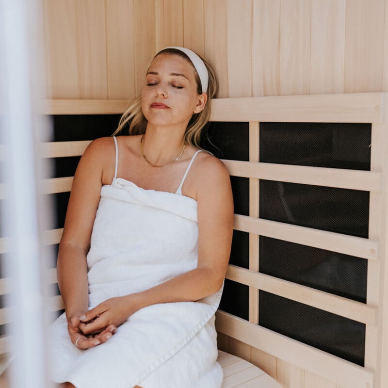 Woman sitting in sauna