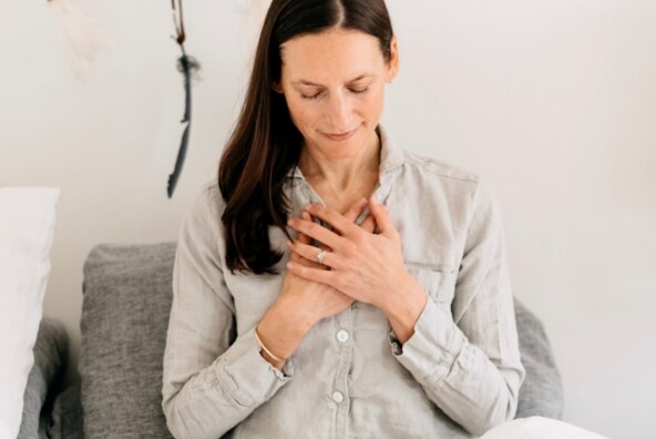 Woman meditating in bed.