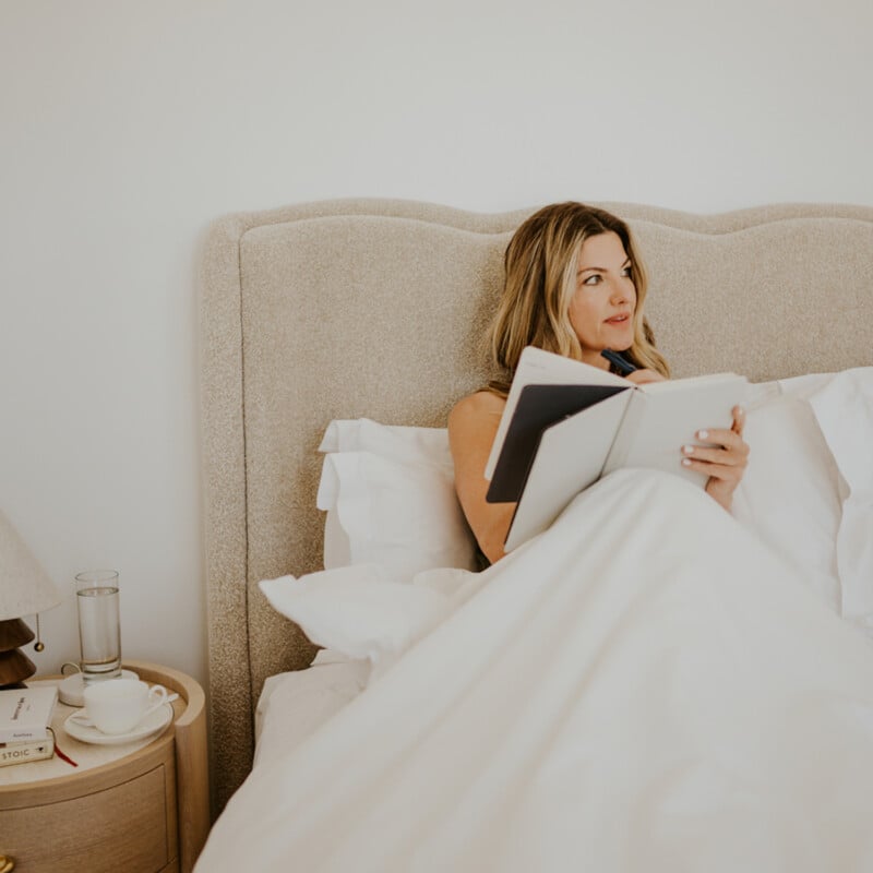 Inge Theron journaling in bed as a part of her wind-down routine.