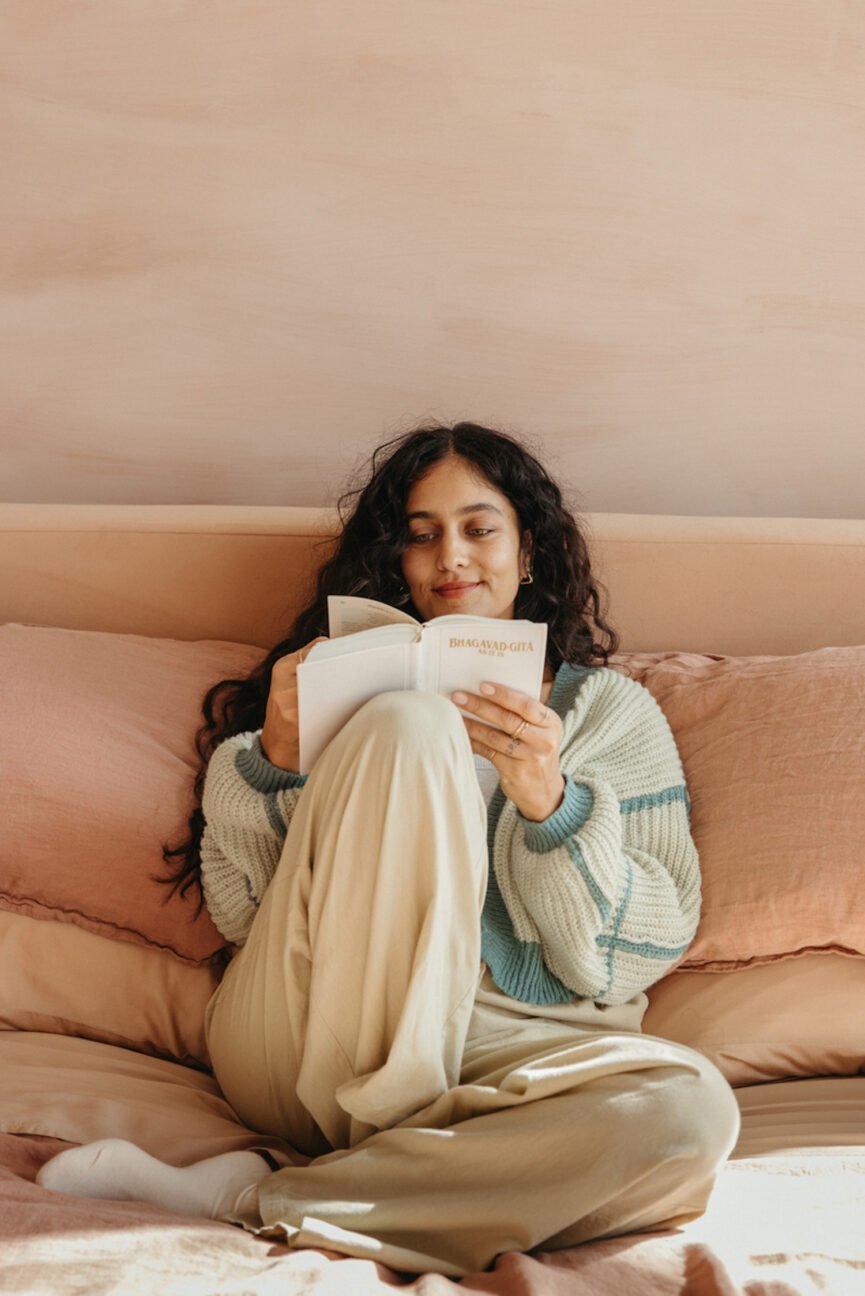 Woman reading about self care for single women.