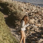 woman walking on beach taking summer solo date