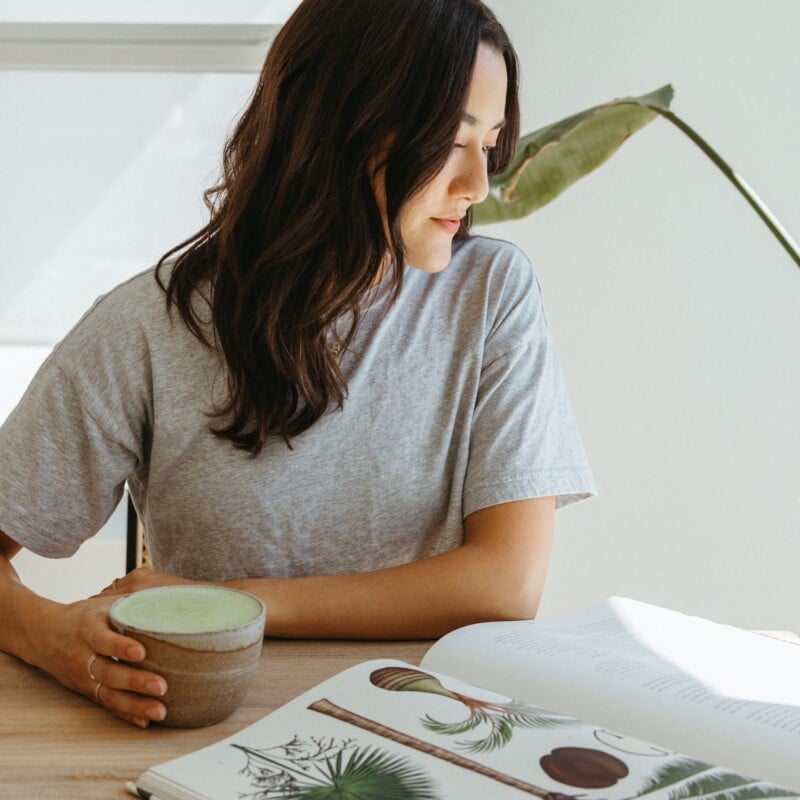 jules acree reading a book drinking matcha
