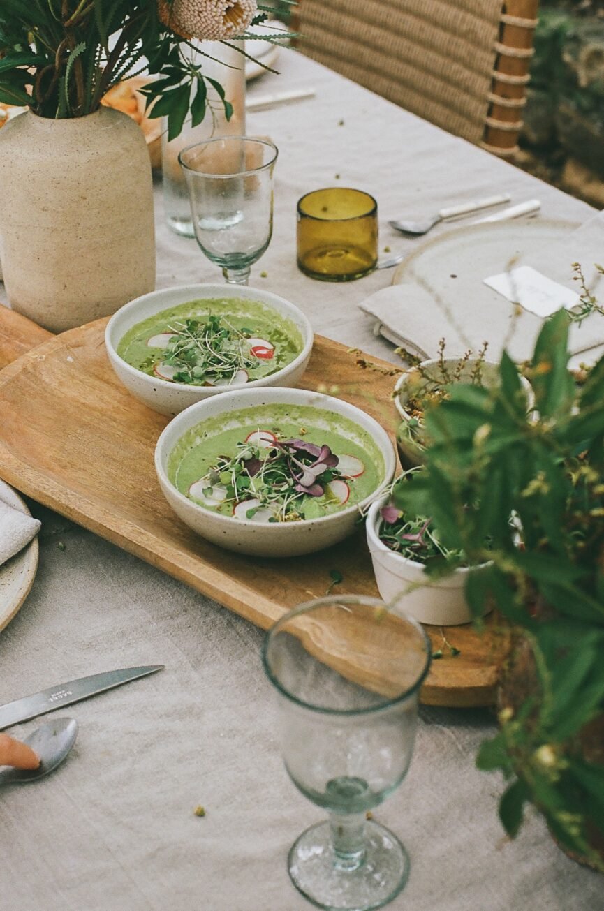pea gazpacho in bowls on outdoor dining table