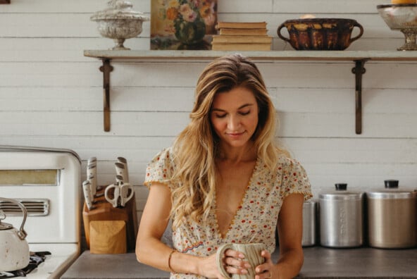 Woman drinking coffee in her soft mornings routine.