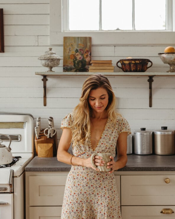 Woman drinking coffee in her soft mornings routine.