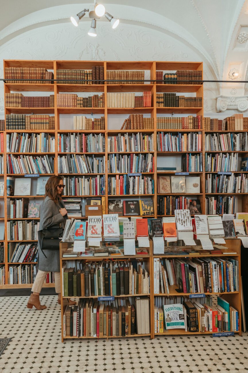 Woman browsing books in bookstore.