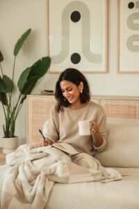 Woman journaling in bed.