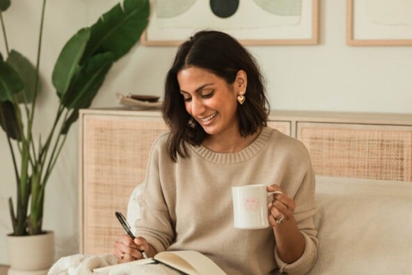 Woman journaling in bed.