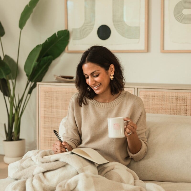Woman journaling in bed.