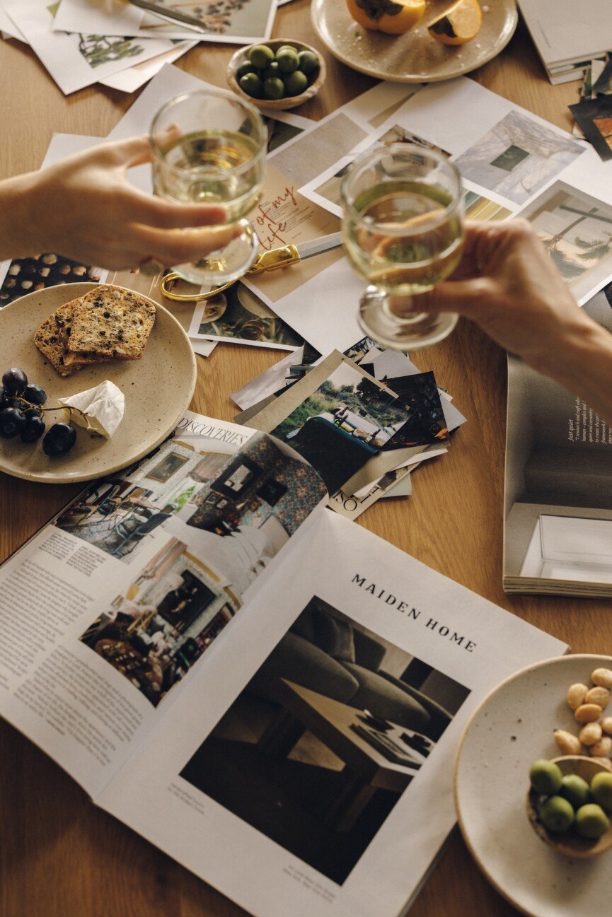 toasting wine glasses at a vision board party