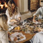 Close friends cutting out images and creating their vision boards together