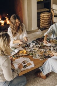 Close friends cutting out images and creating their vision boards together