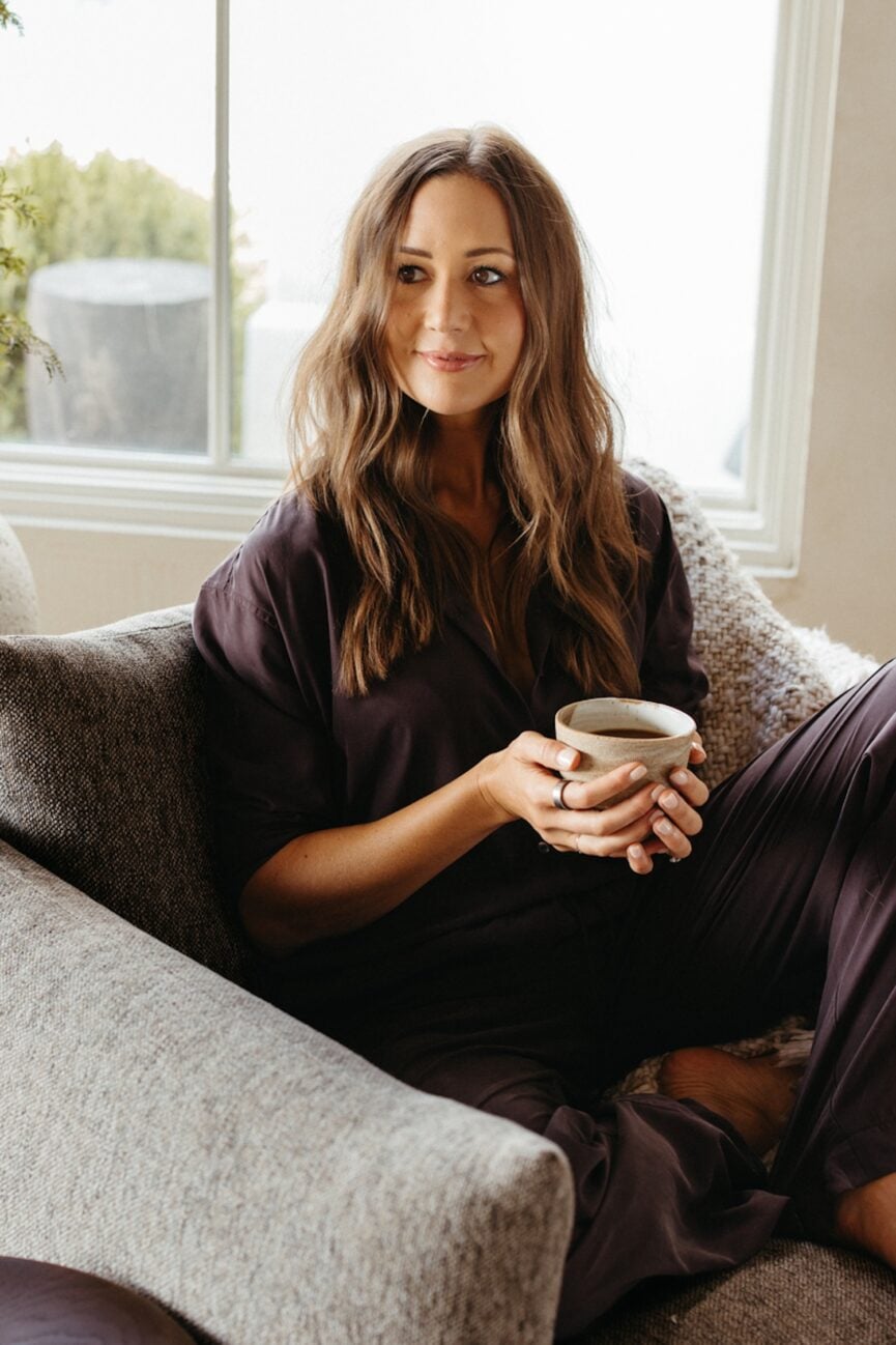 Camille Styles drinking tea and watching the best New Year's Eve movies.