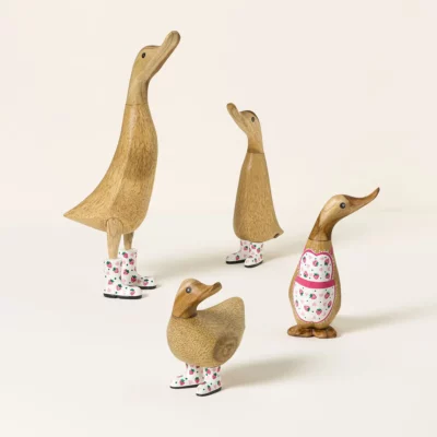 Four decorative garden ducks wearing strawberry-patterned rain boots Copy